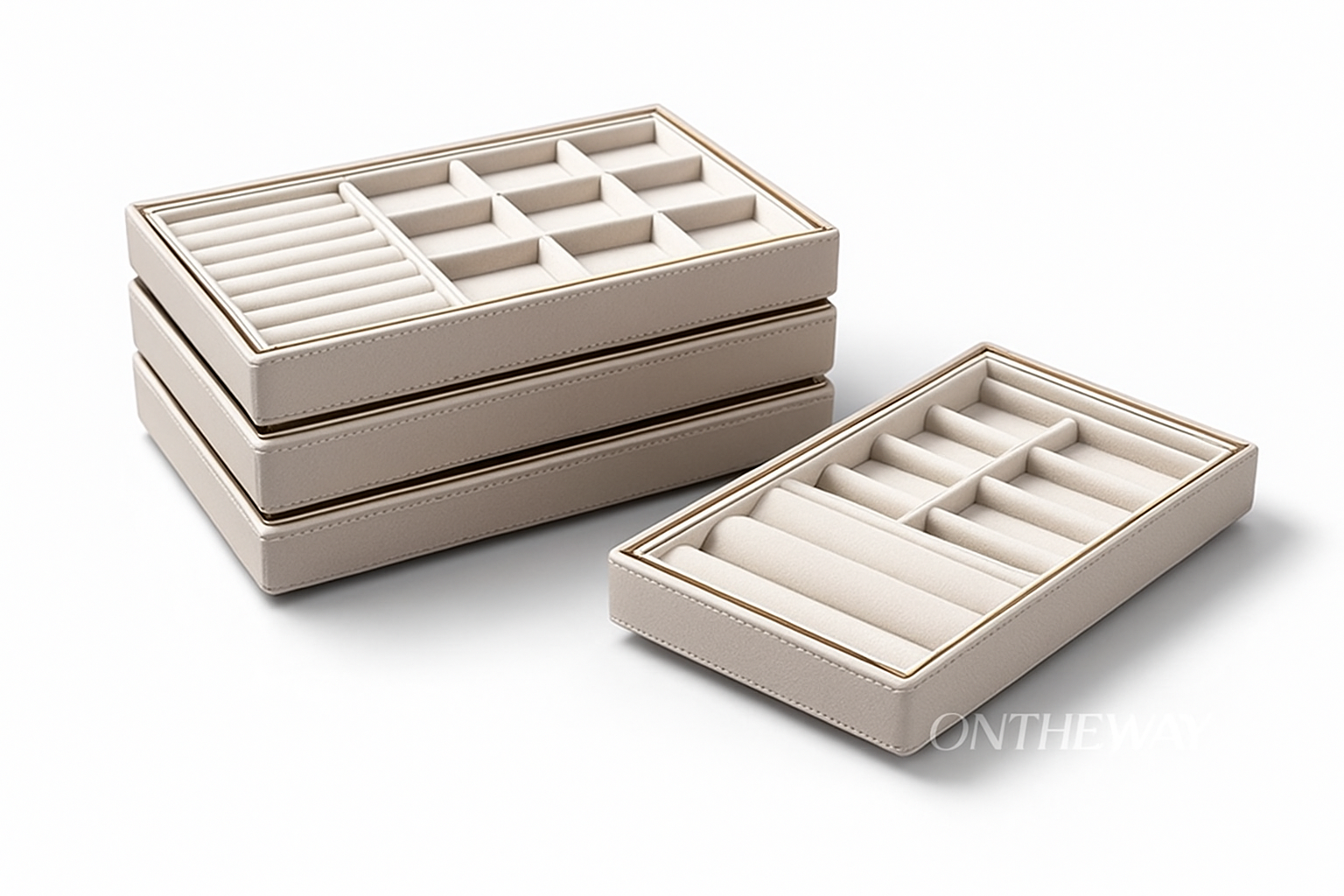 A set of beige stackable jewelry trays designed with multiple compartments, ring slots, and a reinforced frame for container-style organization. Perfect for wholesalers and trade show exhibitors, these trays offer efficient stacking, secure transport, and professional jewelry presentation. A subtle ONTHEWAY watermark appears in the bottom right corner.