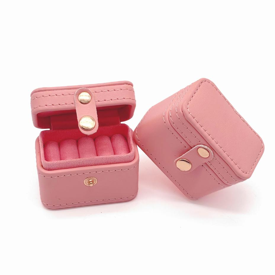 This sturdy cubic leather jewelry box is perfect for short trips—compact, durable, and stylish.