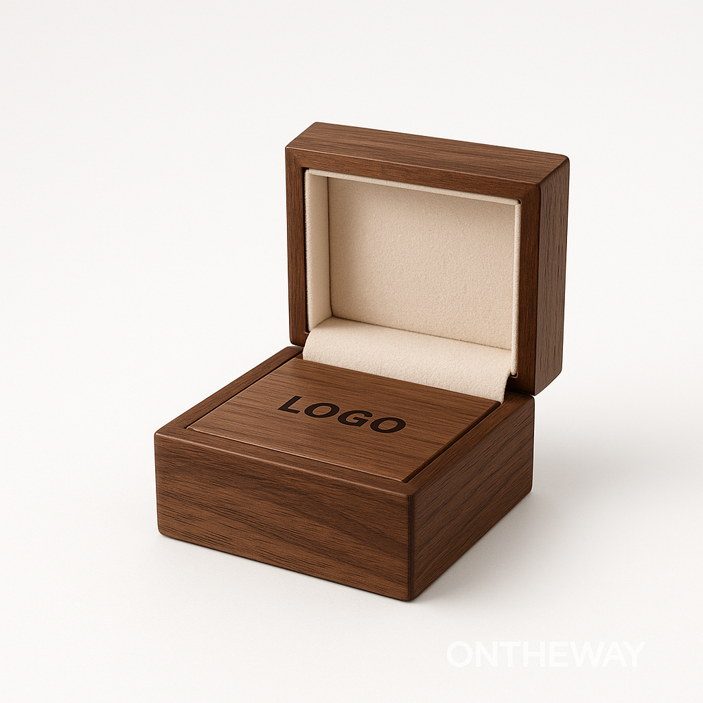 Open walnut wooden ring box with beige velvet interior and engraved custom logo on the lid, designed for premium jewelry branding and personalized packaging.